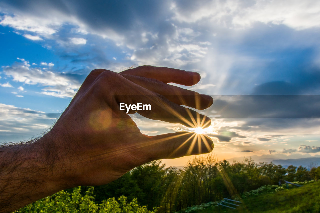 View of sunlight through hand