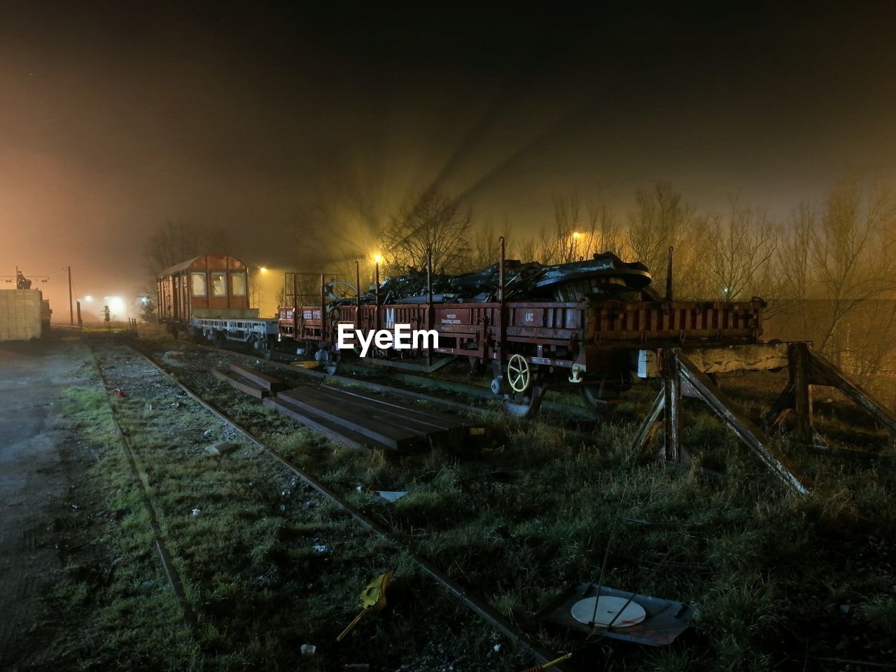 TRAIN ON RAILROAD TRACK AT NIGHT