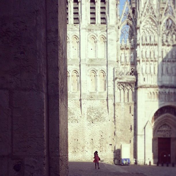 WOMAN STANDING IN FRONT OF BUILDING