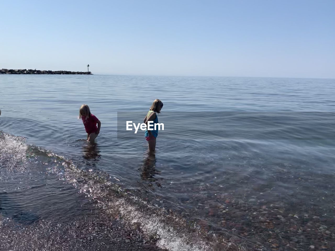 CHILDREN ON SEA AGAINST CLEAR SKY