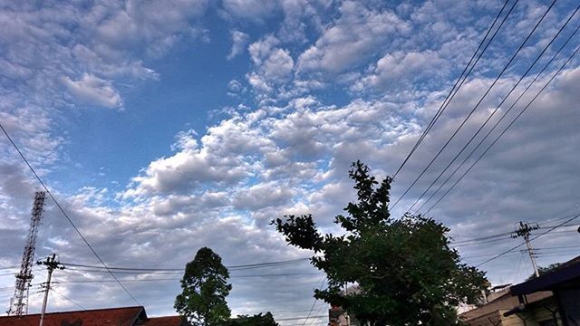 LOW ANGLE VIEW OF POWER LINES AGAINST CLOUDY SKY