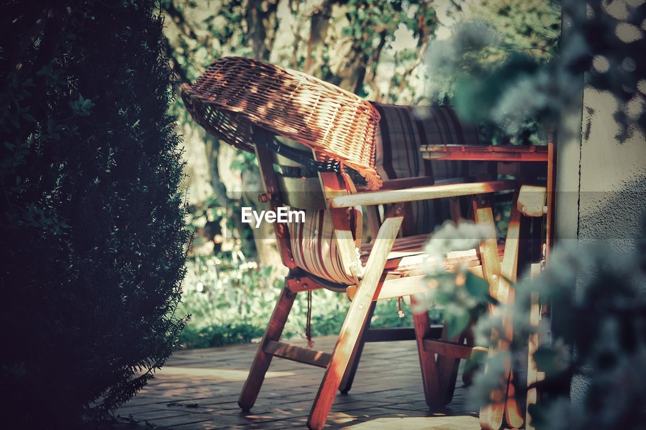 EMPTY CHAIR AND TABLE IN YARD