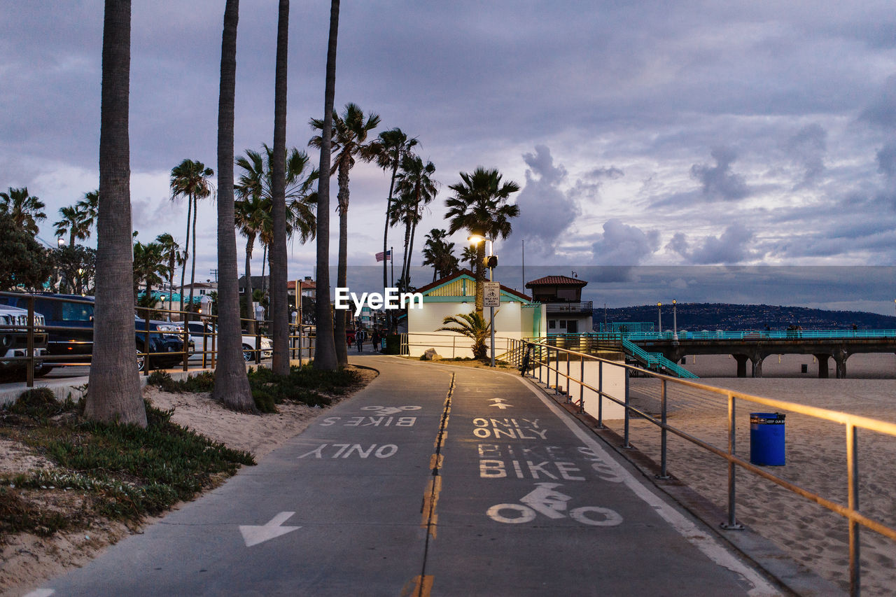 High angle view of road sign by beach at dusk