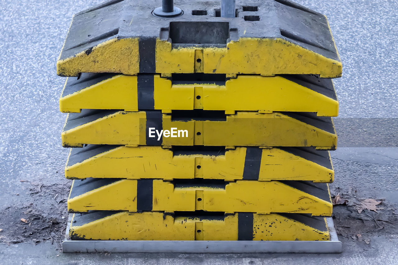 LOW ANGLE VIEW OF YELLOW SIGN ON METAL WALL