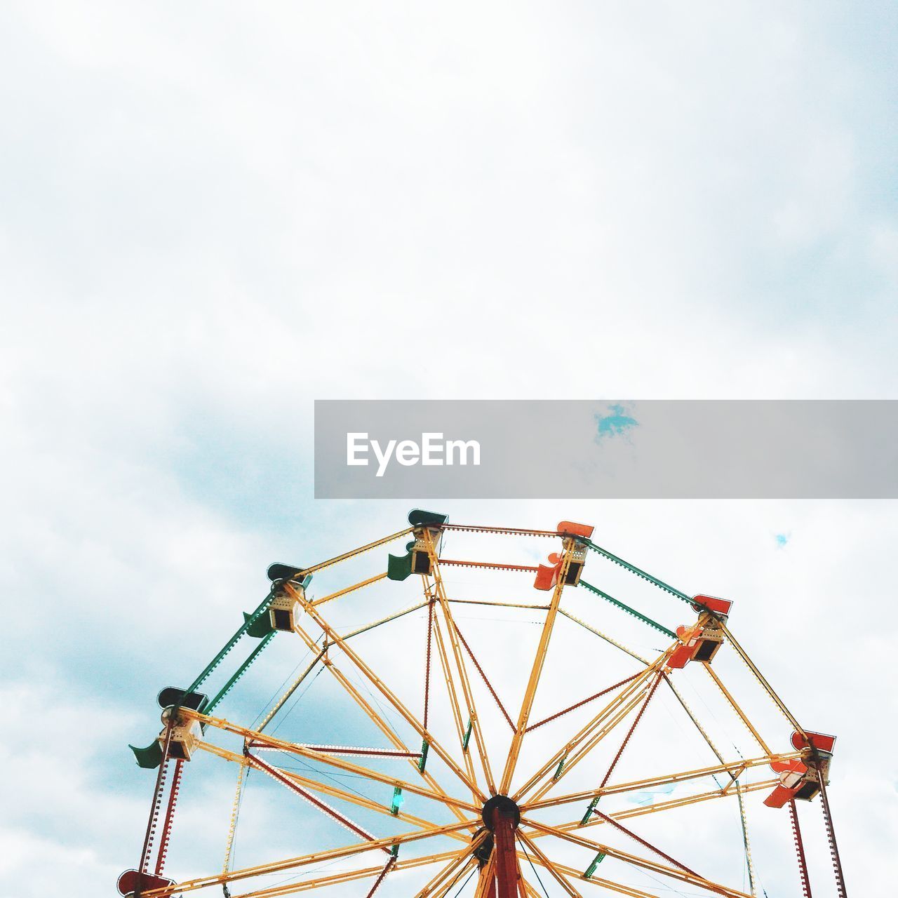 Low angle view of ferris wheel against sky