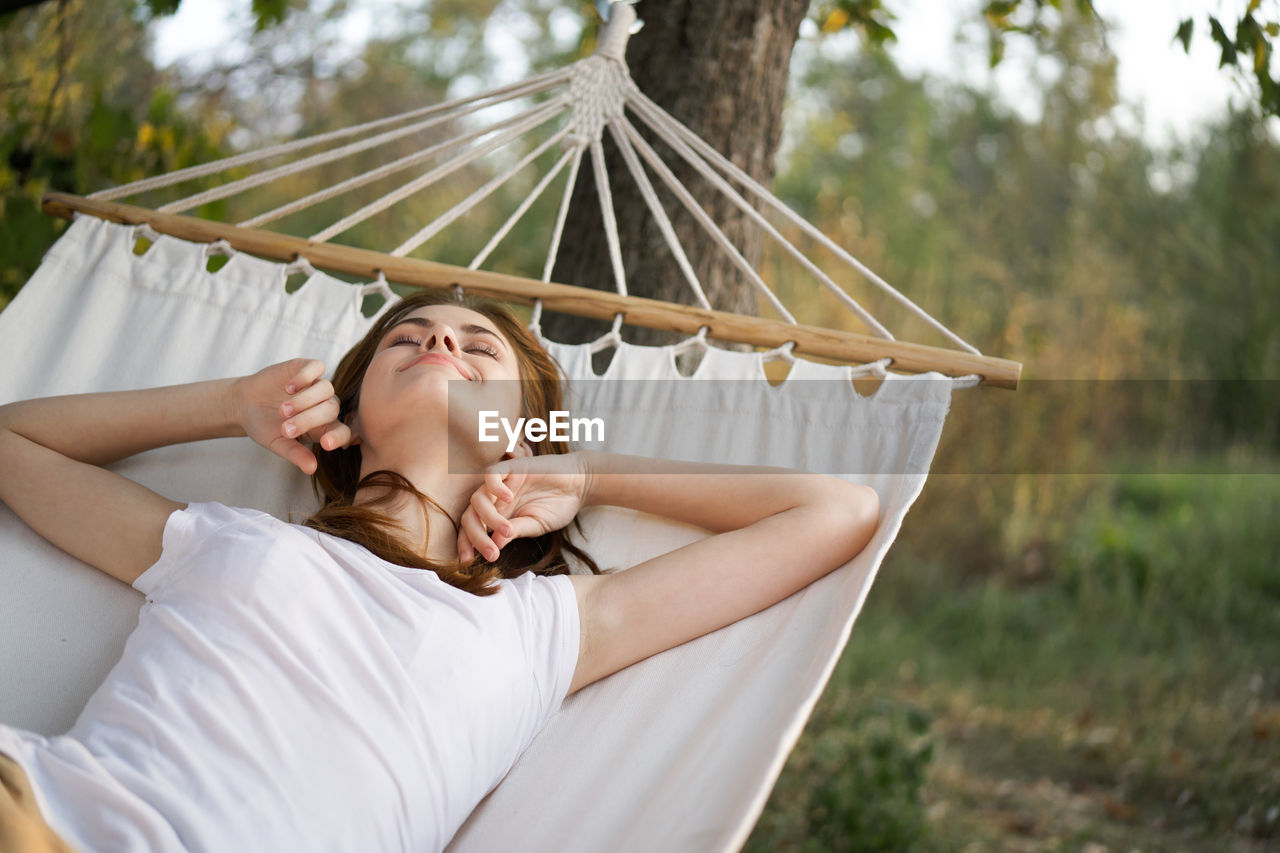 Woman lying on hammock