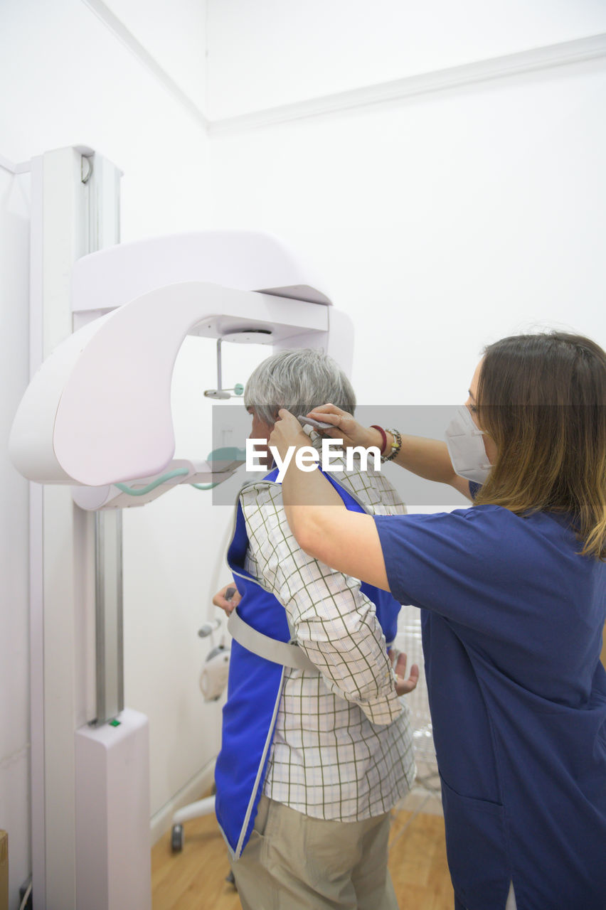 Rear view of women standing in bathroom