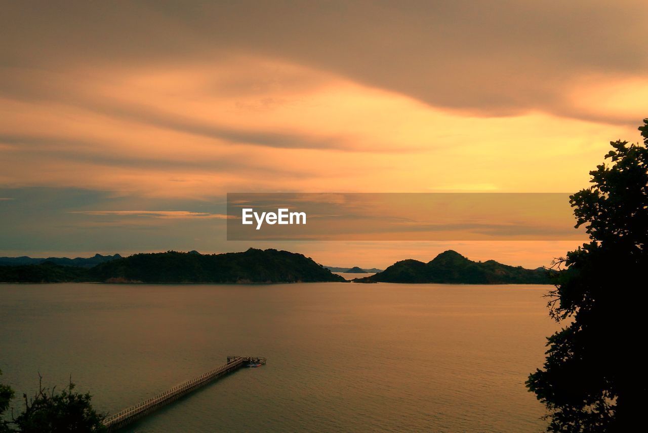 Scenic view of lake against orange sky