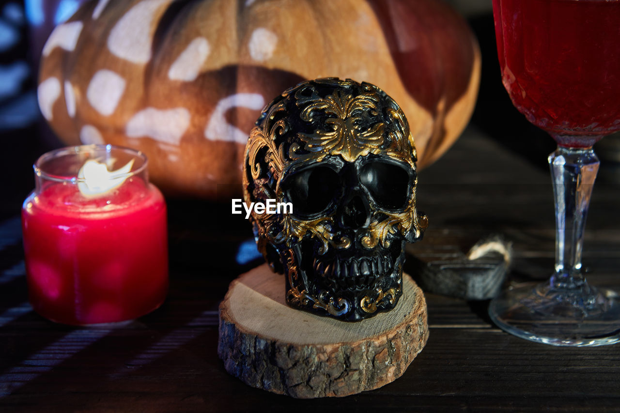 CLOSE-UP OF CANDLES ON WOODEN TABLE