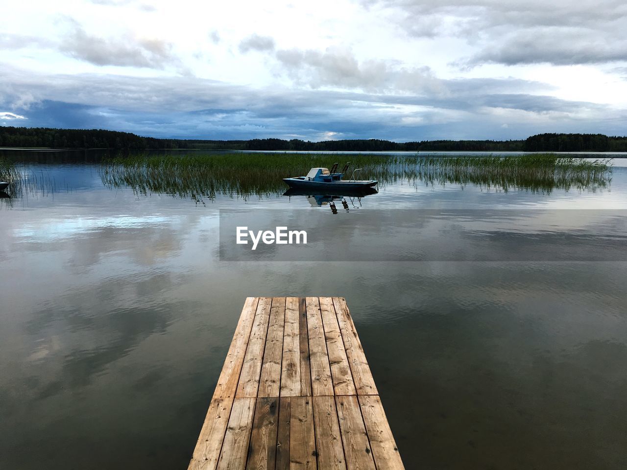 PEOPLE ON LAKE AGAINST SKY