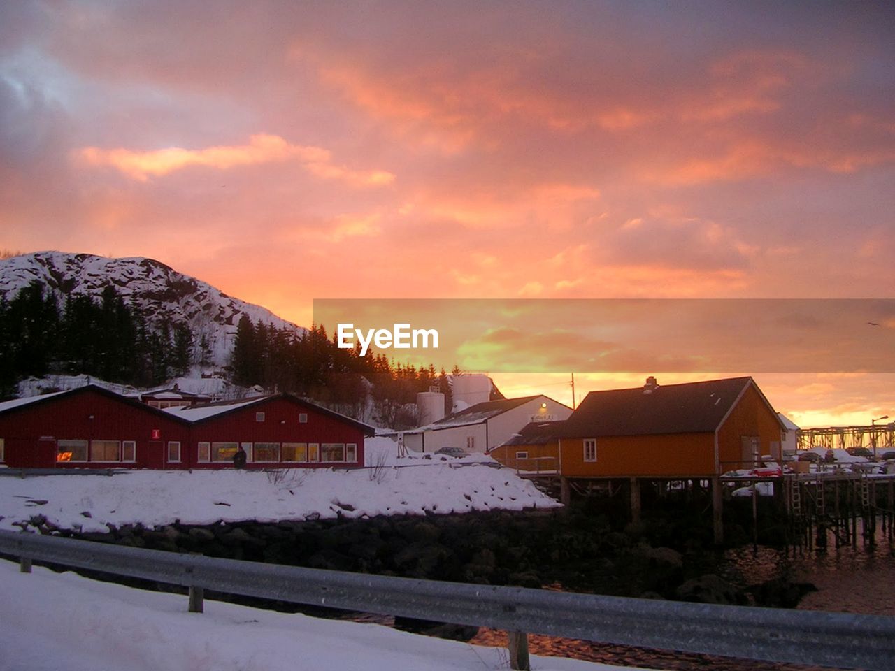 HOUSES AND BUILDINGS AGAINST SKY DURING SUNSET