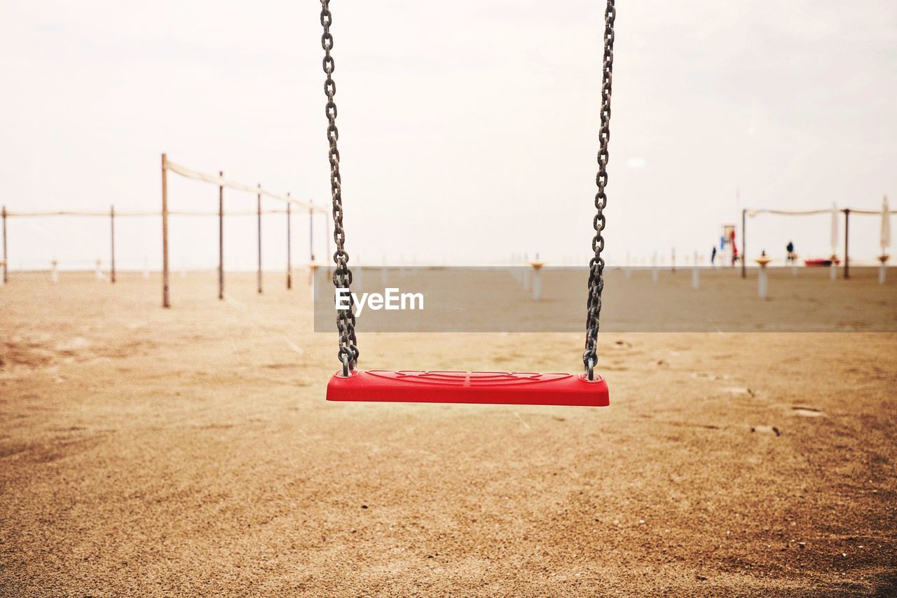 Empty swing against sky in park