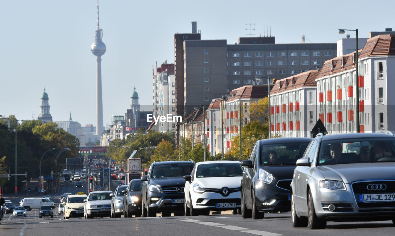 CARS ON STREET BY BUILDINGS IN CITY