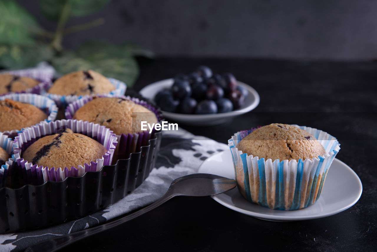 Delicious homemade cupcakes filled with blueberries and presented in small molds.