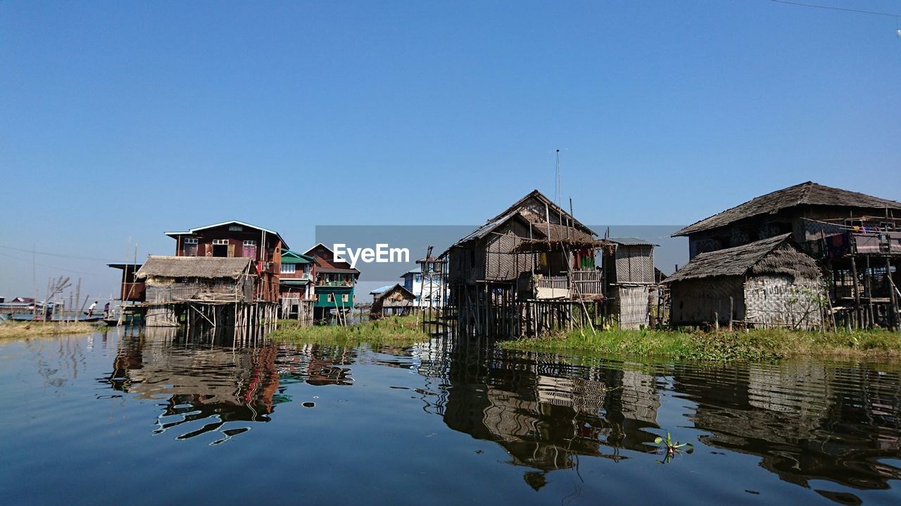 Reflection of houses in calm lake