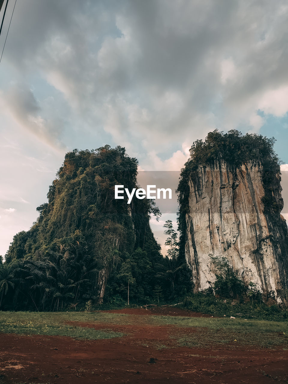 Rock formations on field against sky