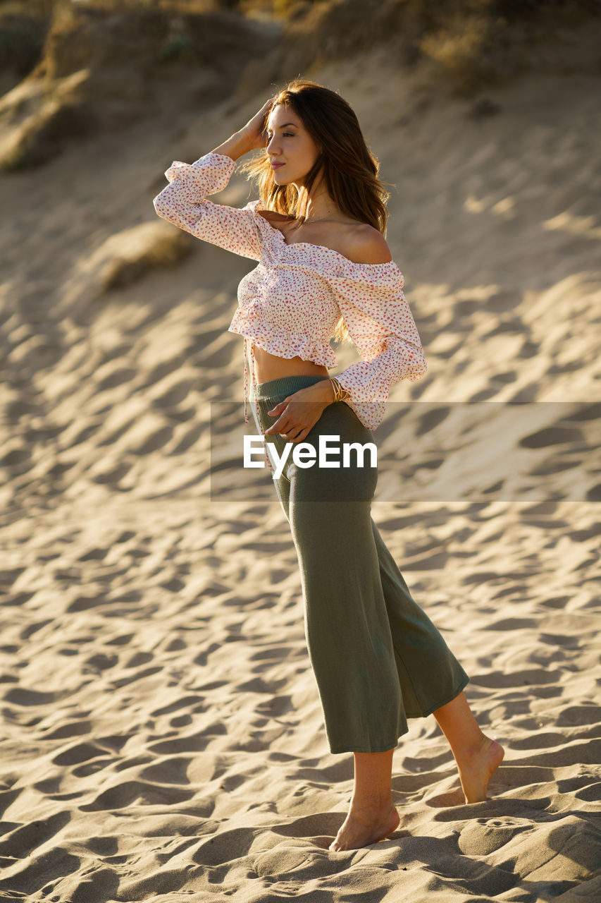 Full length of woman standing on beach