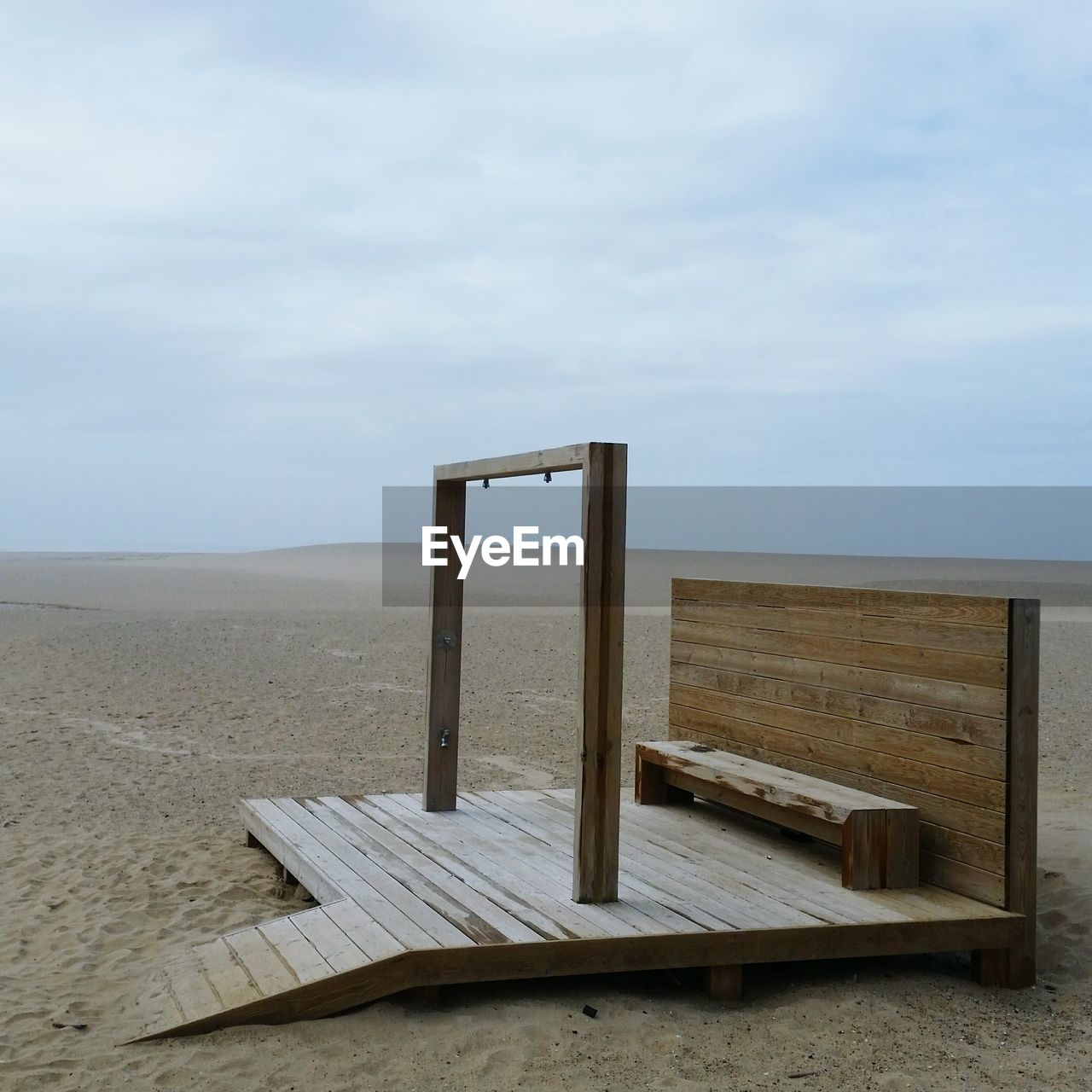 CHAIR ON SHORE AGAINST SKY