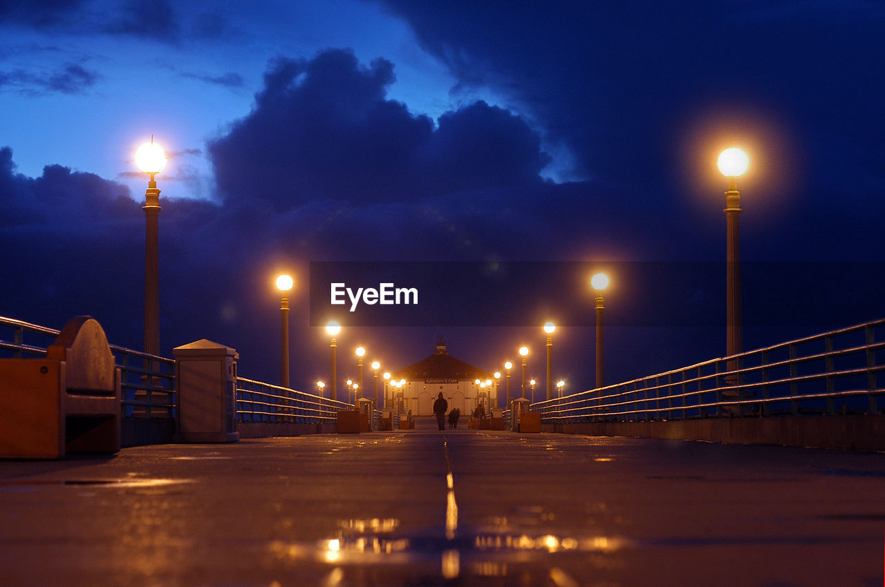 View of illuminated pier at night