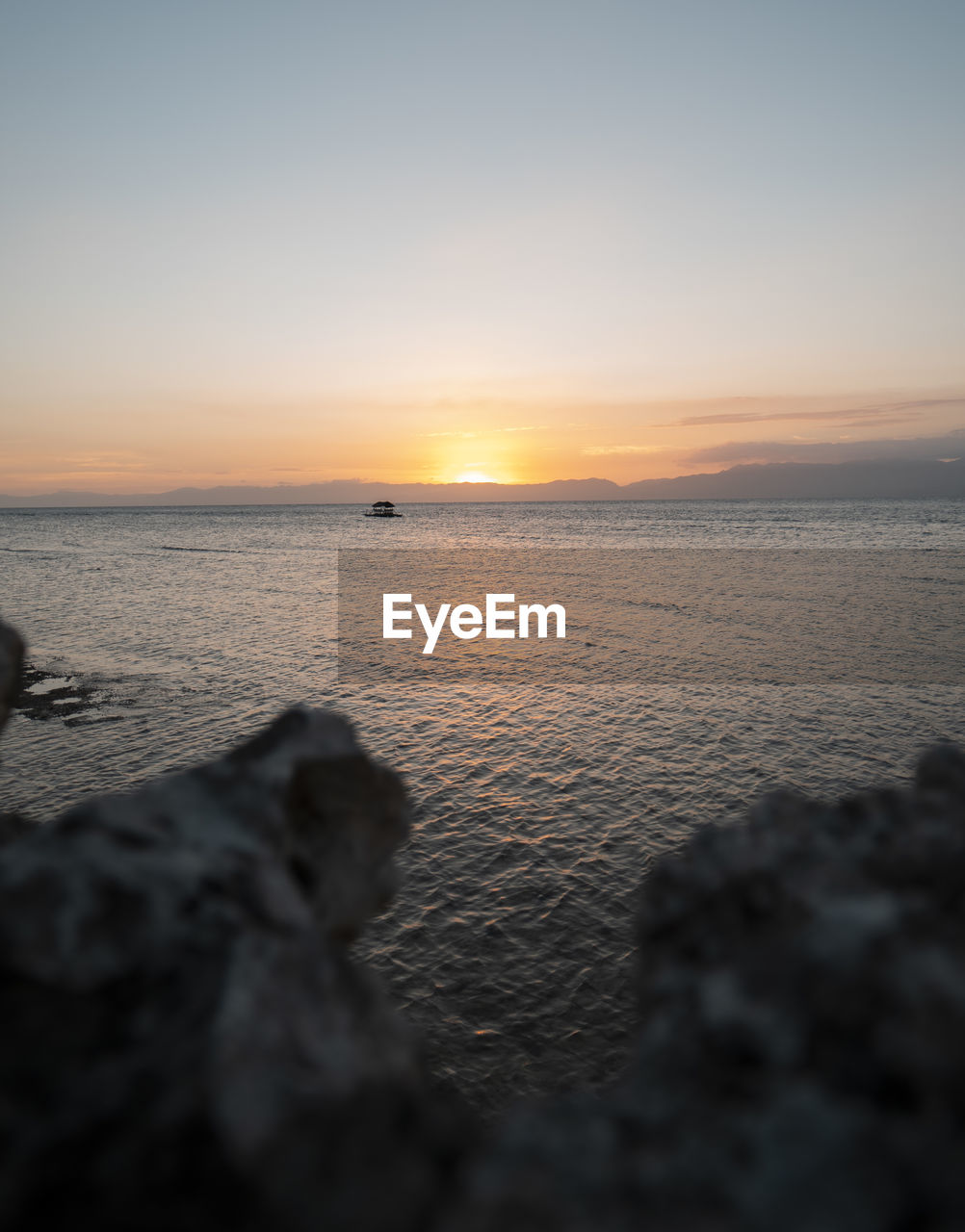 SCENIC VIEW OF BEACH AGAINST SKY DURING SUNSET