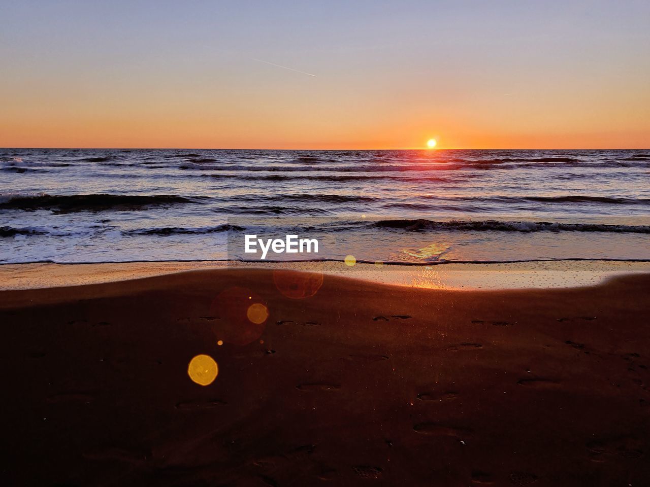 Scenic view of sea against sky during sunset