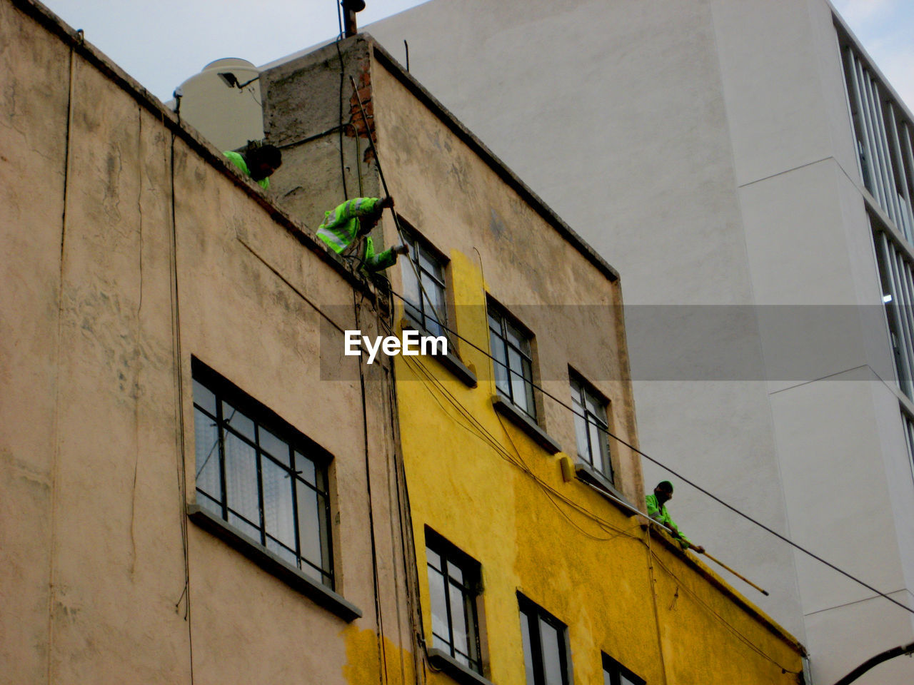 Low angle view of yellow building against sky