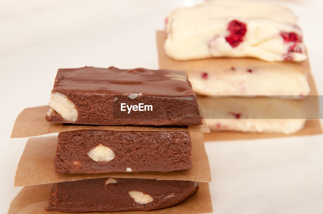 CLOSE-UP OF CHOCOLATE CAKE ON STACK OF BREAD