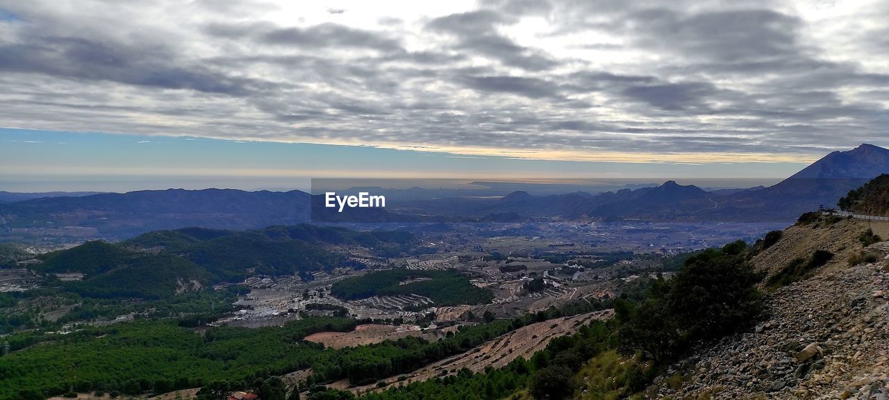 SCENIC VIEW OF LANDSCAPE AND MOUNTAINS AGAINST SKY