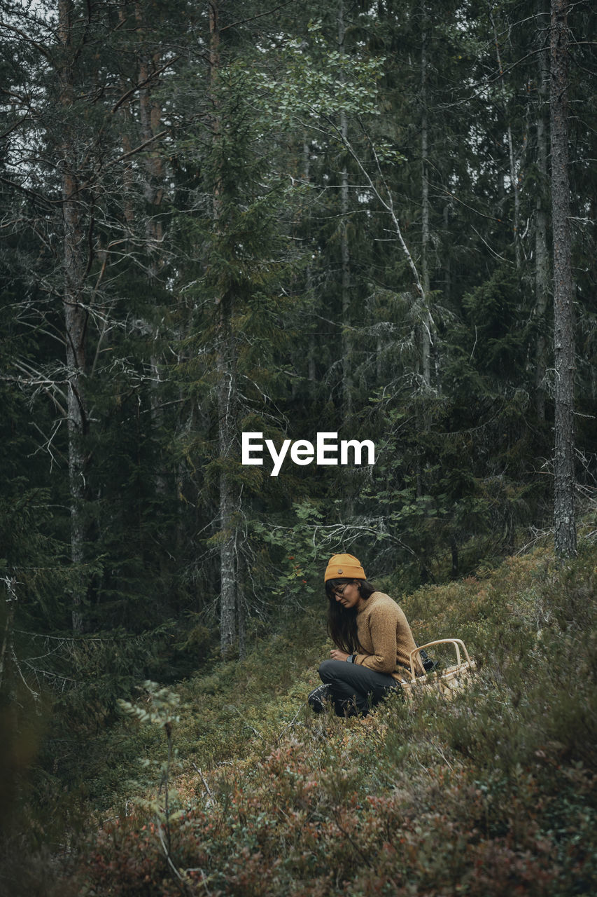 Woman picking mushrooms in forest