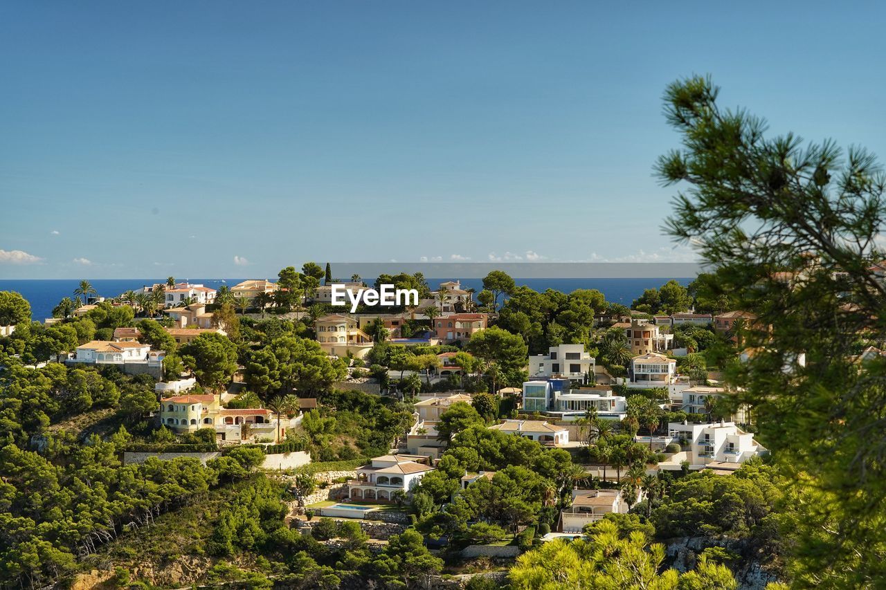 High angle view of townscape against clear blue sky