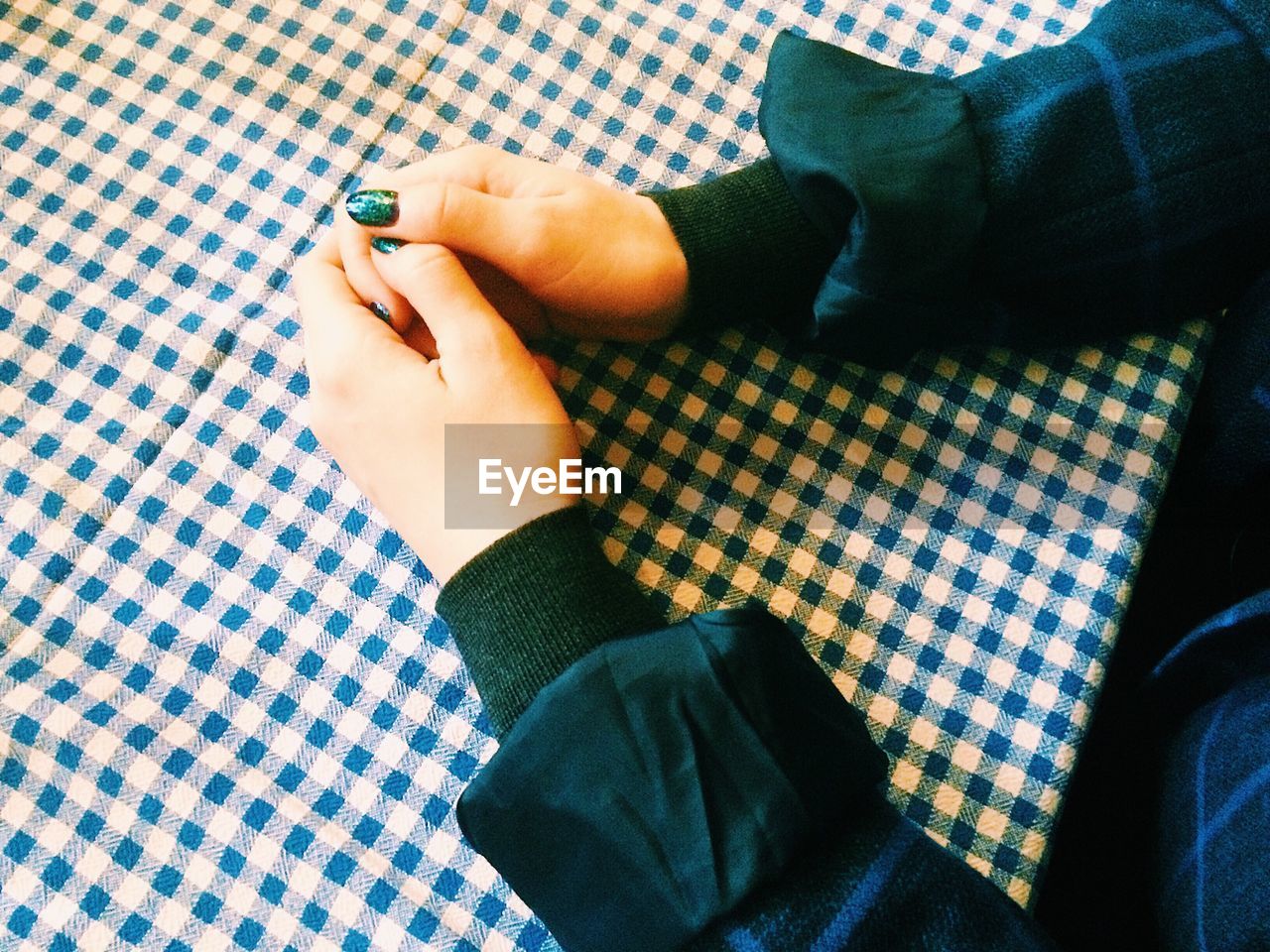 Cropped hands of woman on table