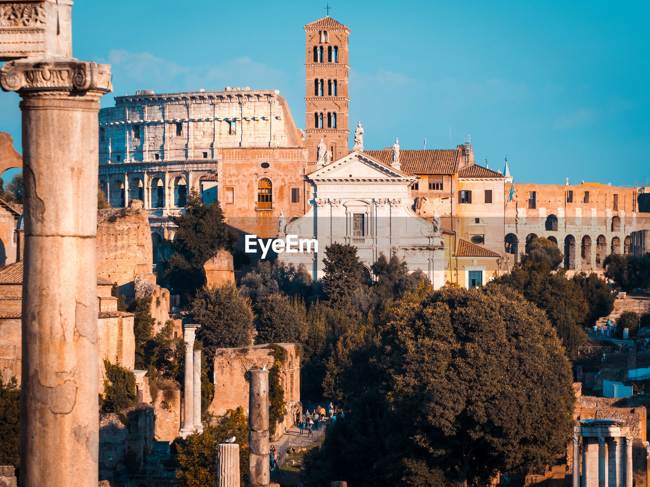 Buildings in city against sky, coloseum and rome