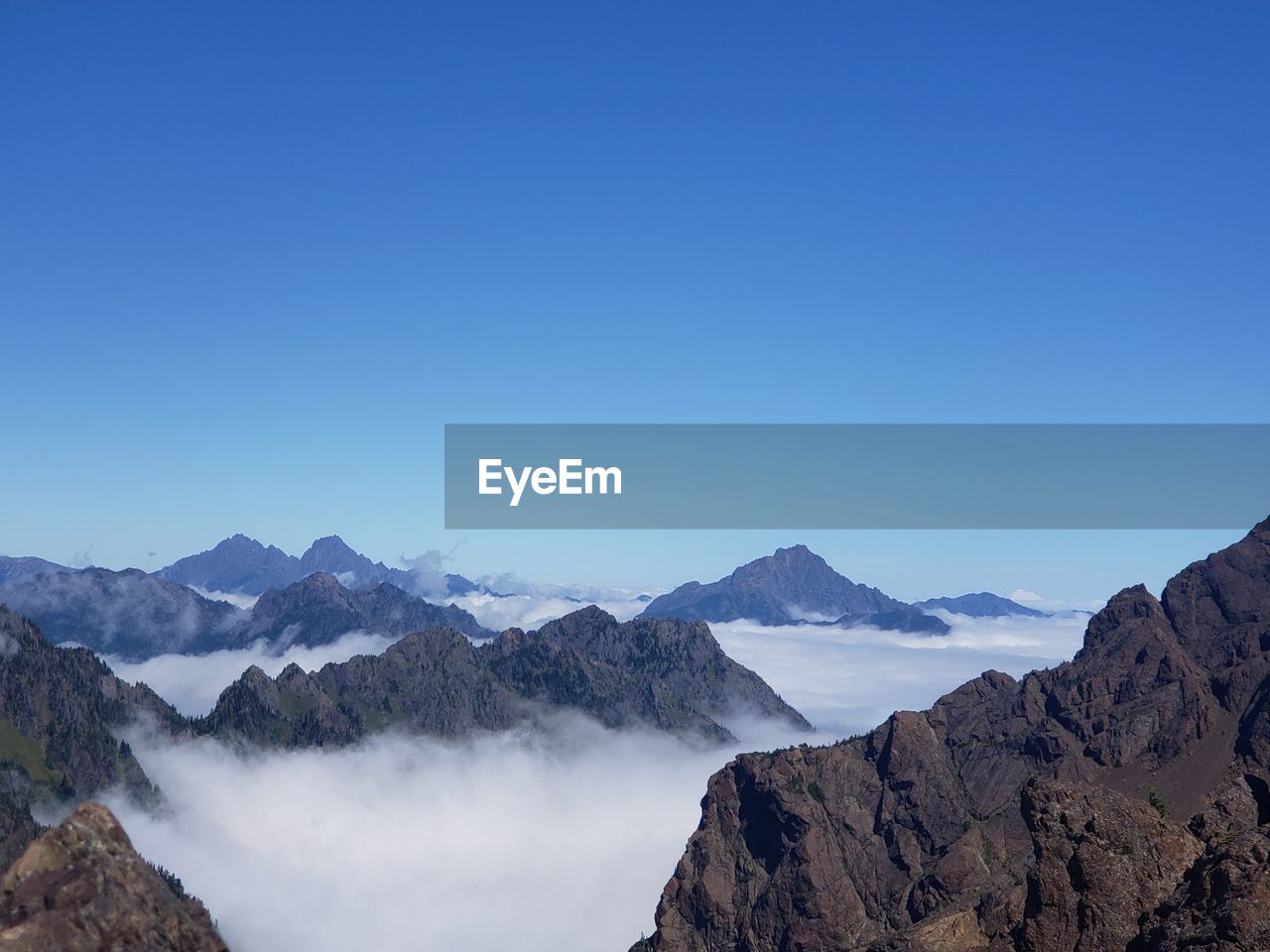 Scenic view of mountains against clear blue sky