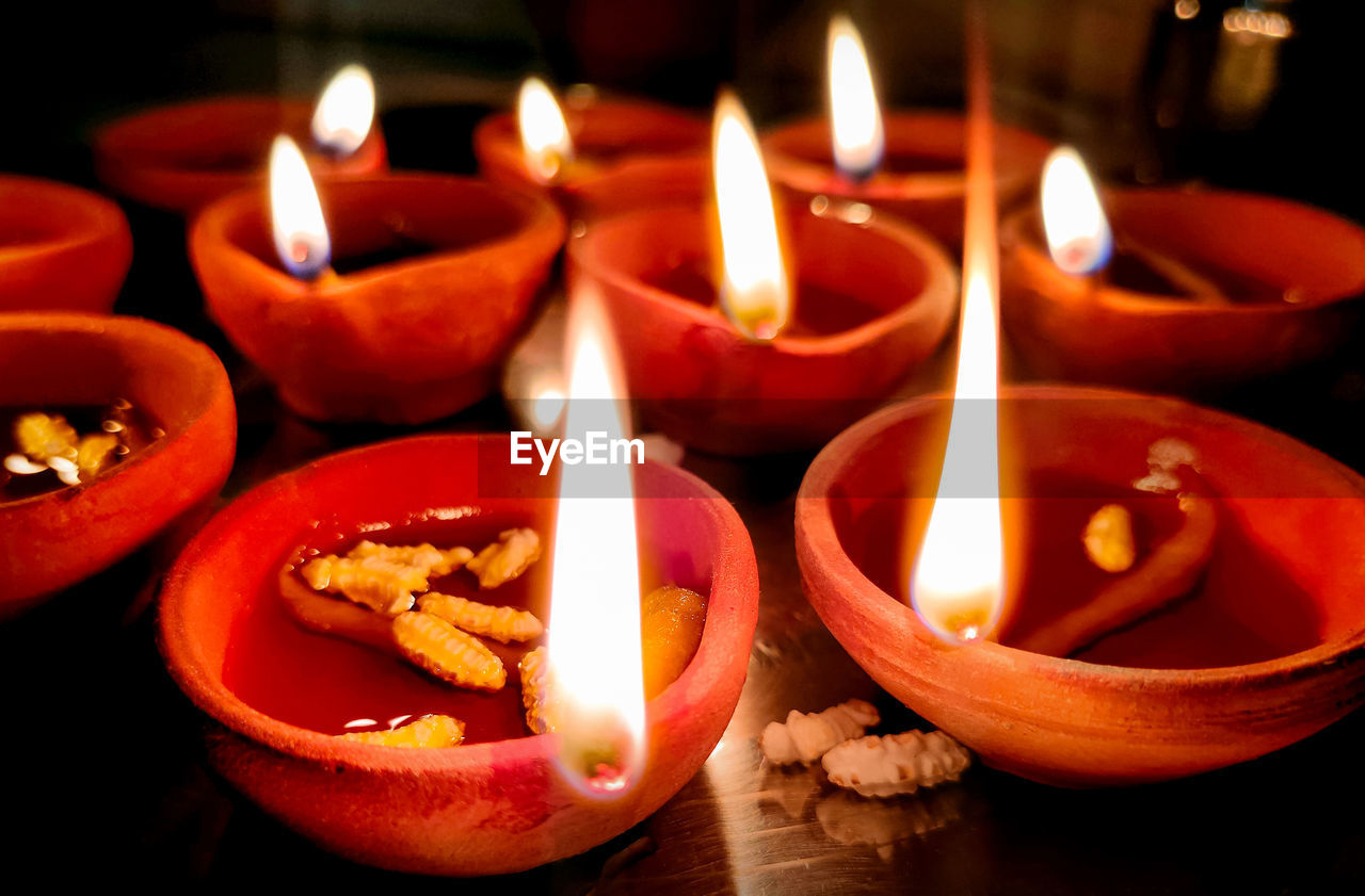 A closup of diya lamp with fire. traditional diwali festival