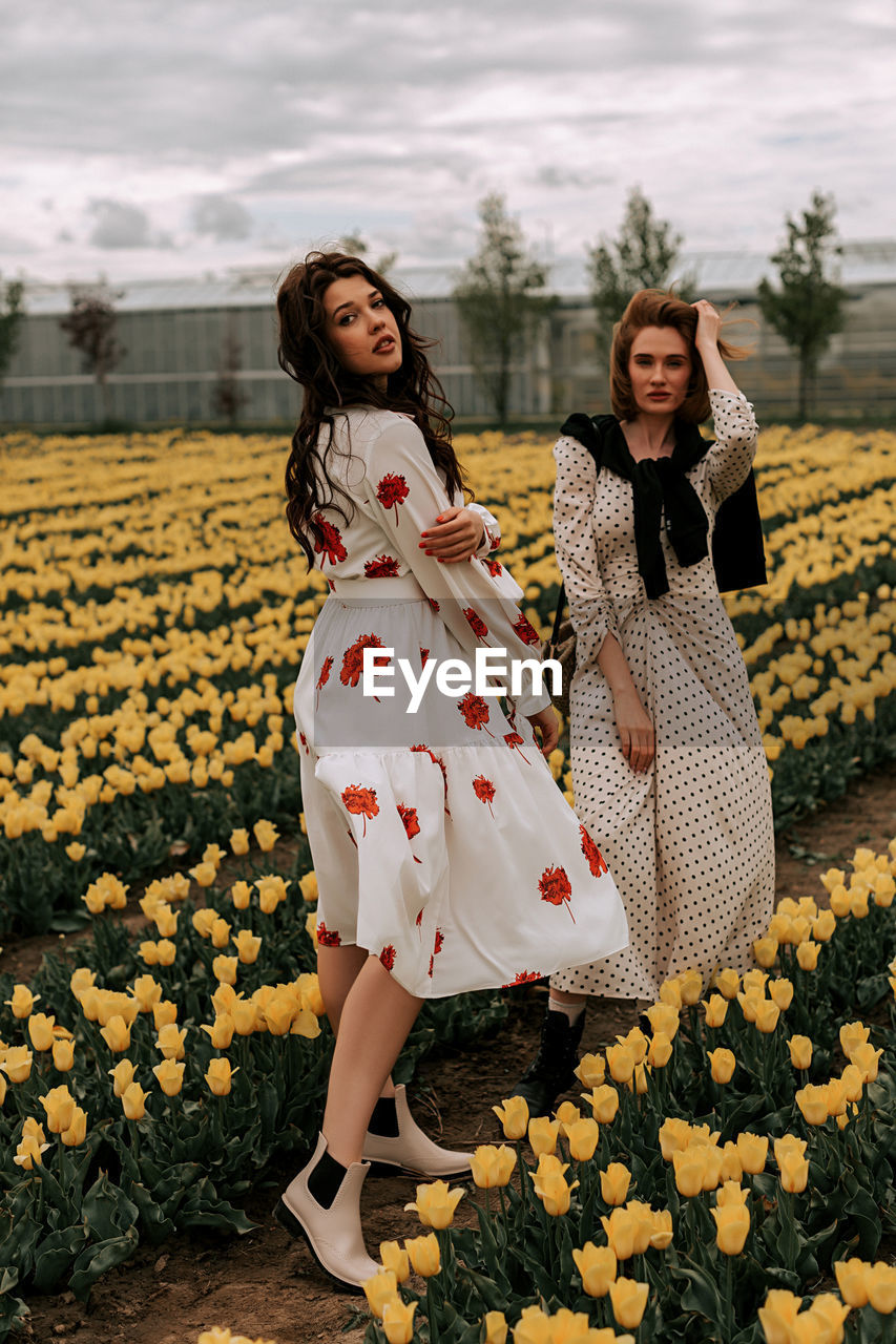 Flowers in a field with beautiful girls. huge selection of tulips and rapeseed