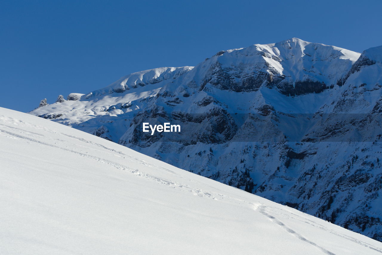 Scenic view of snowcapped mountains against sky