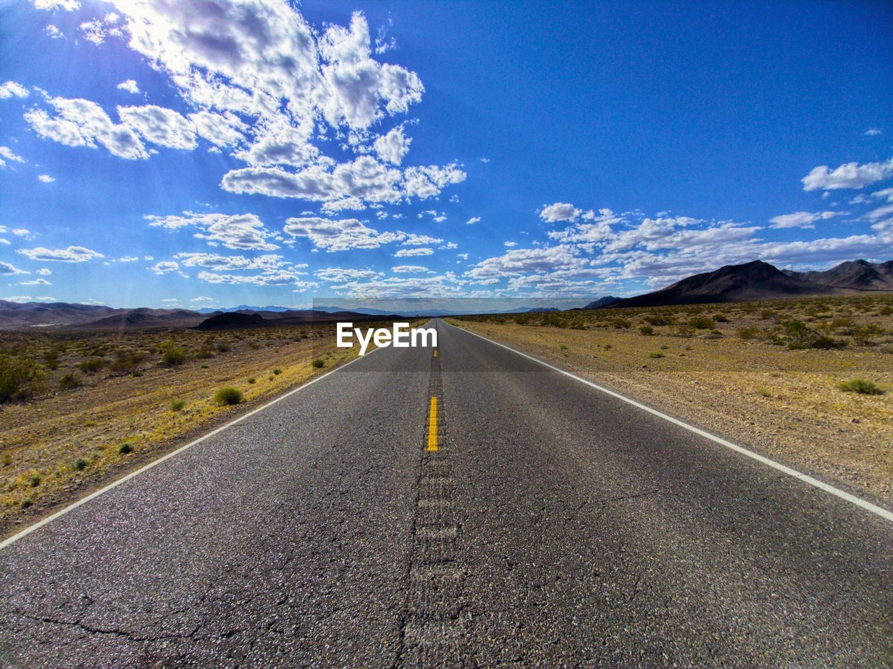 Road amidst landscape against sky