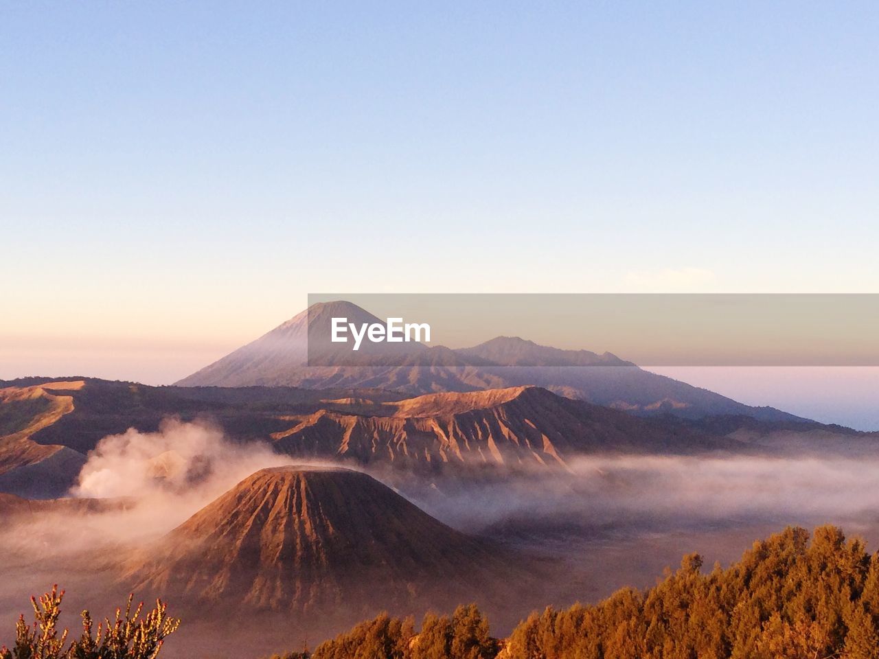 Scenic view of rocky mountains against clear sky on sunny day