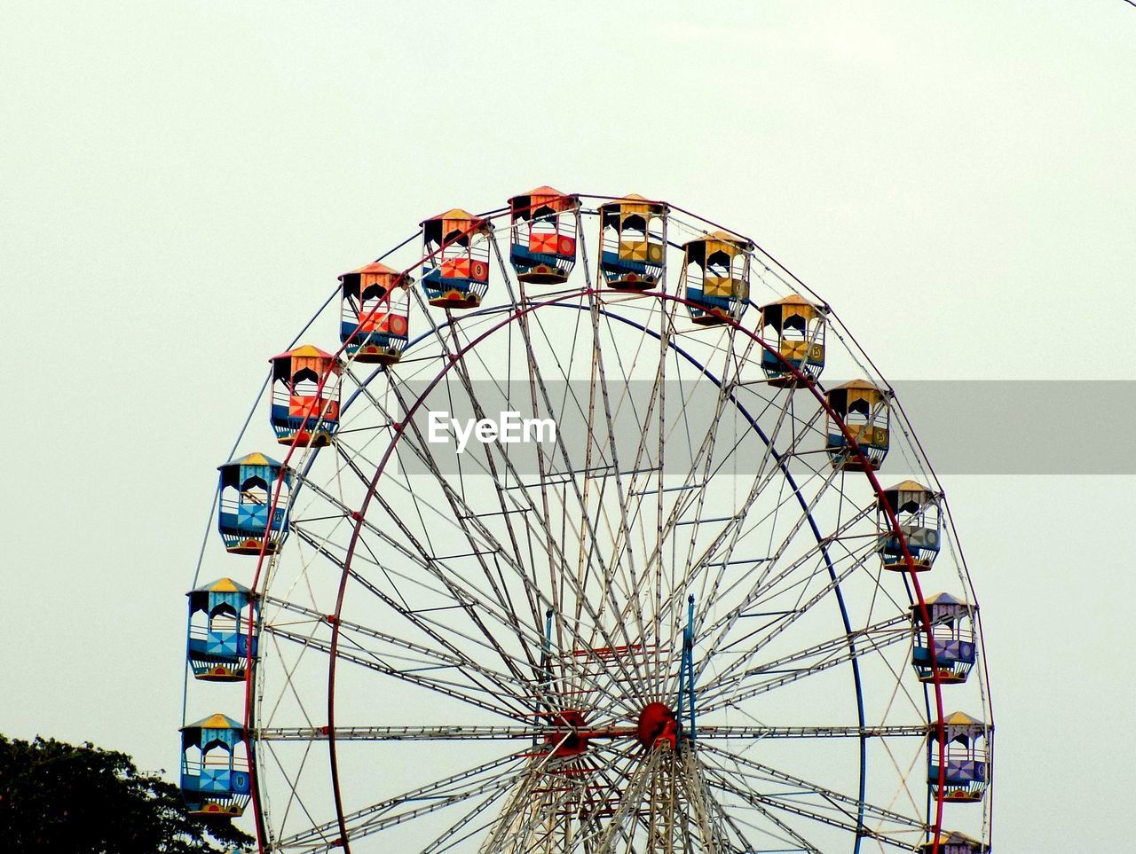 Low angle view of ferris wheel against sky