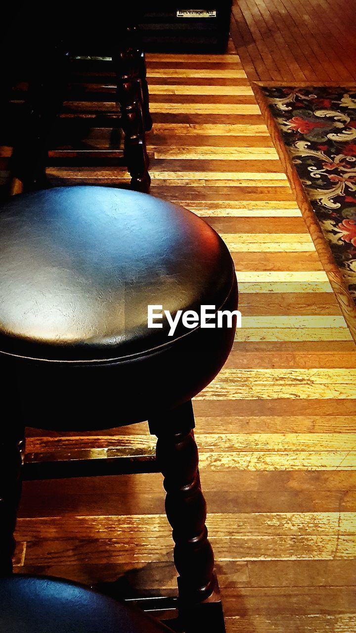 CLOSE-UP OF WOODEN TABLE AND SPOON IN PLATE