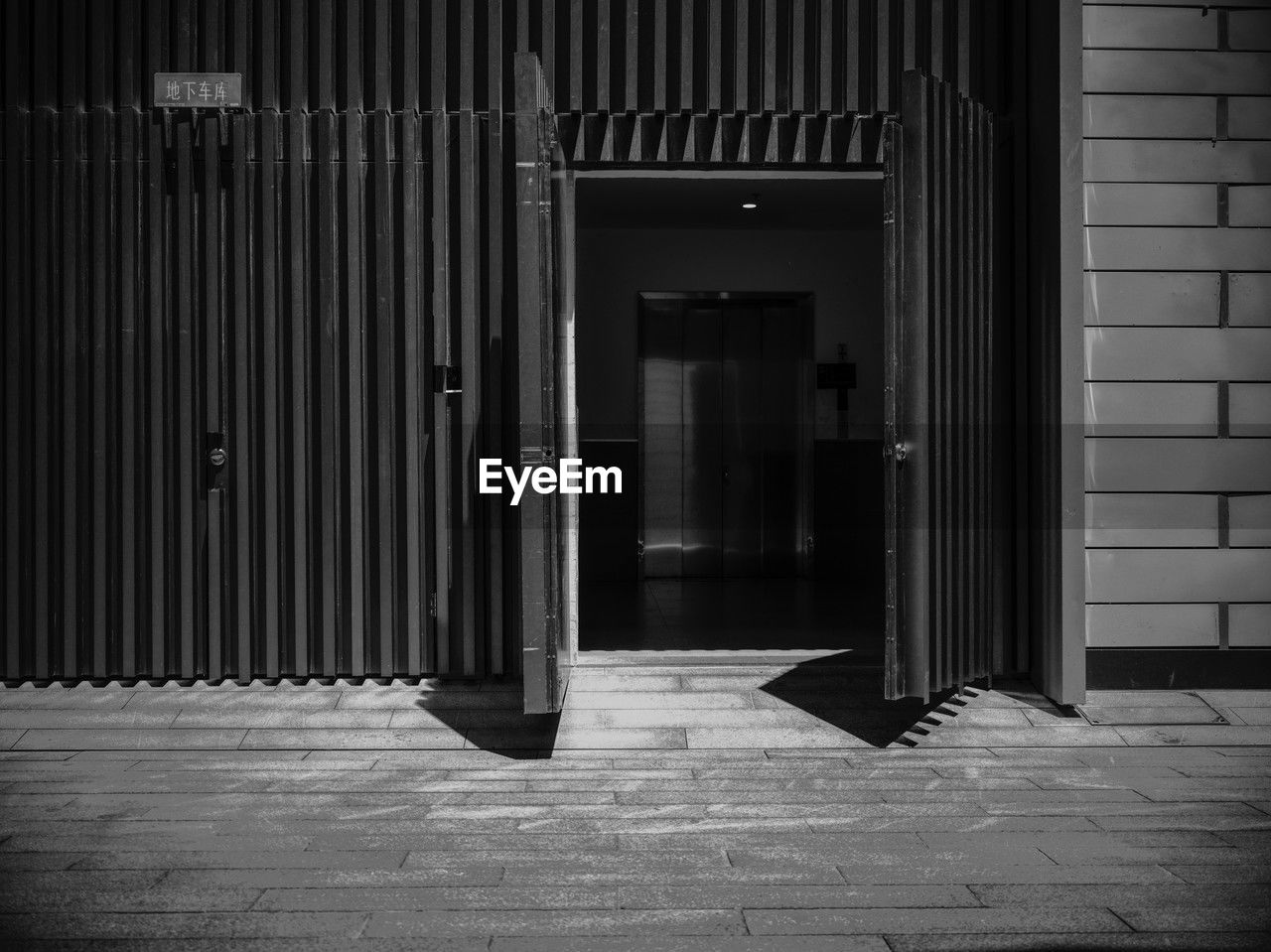 black, white, black and white, architecture, darkness, entrance, door, monochrome, built structure, monochrome photography, closed, building, no people, light, building exterior, house, day, security, outdoors, footpath, open, doorway