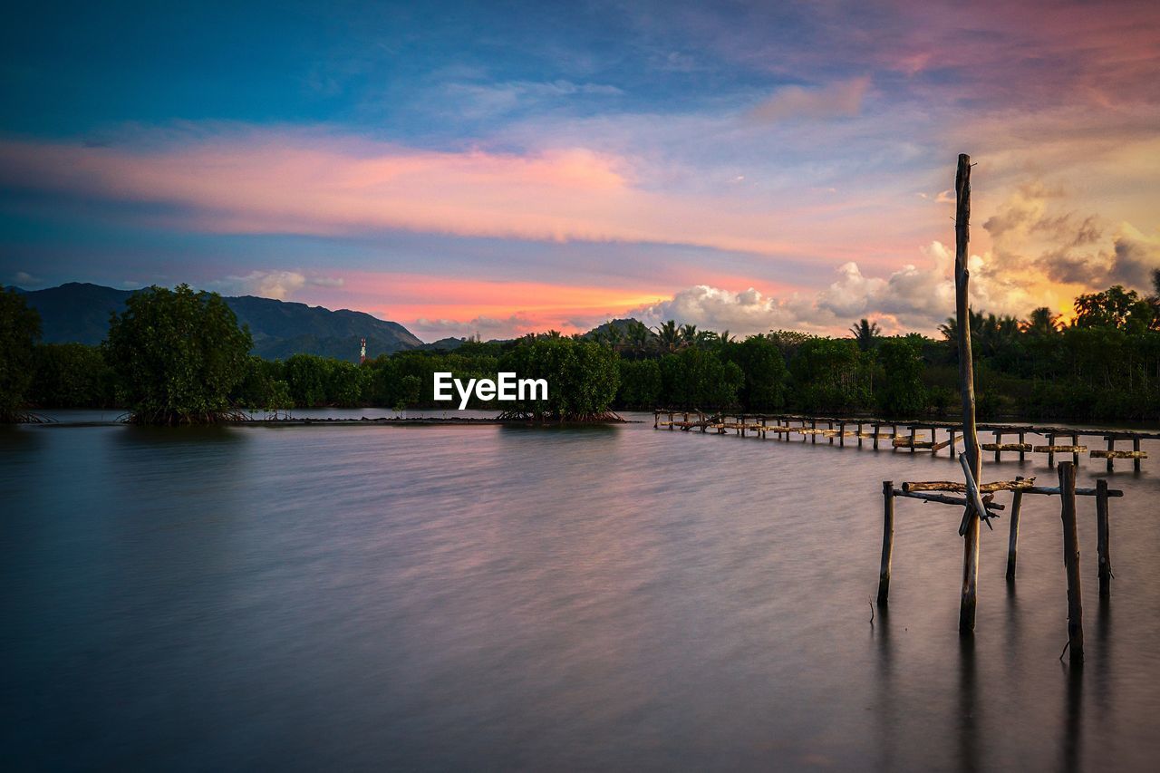 Scenic view of lake against sky during sunset