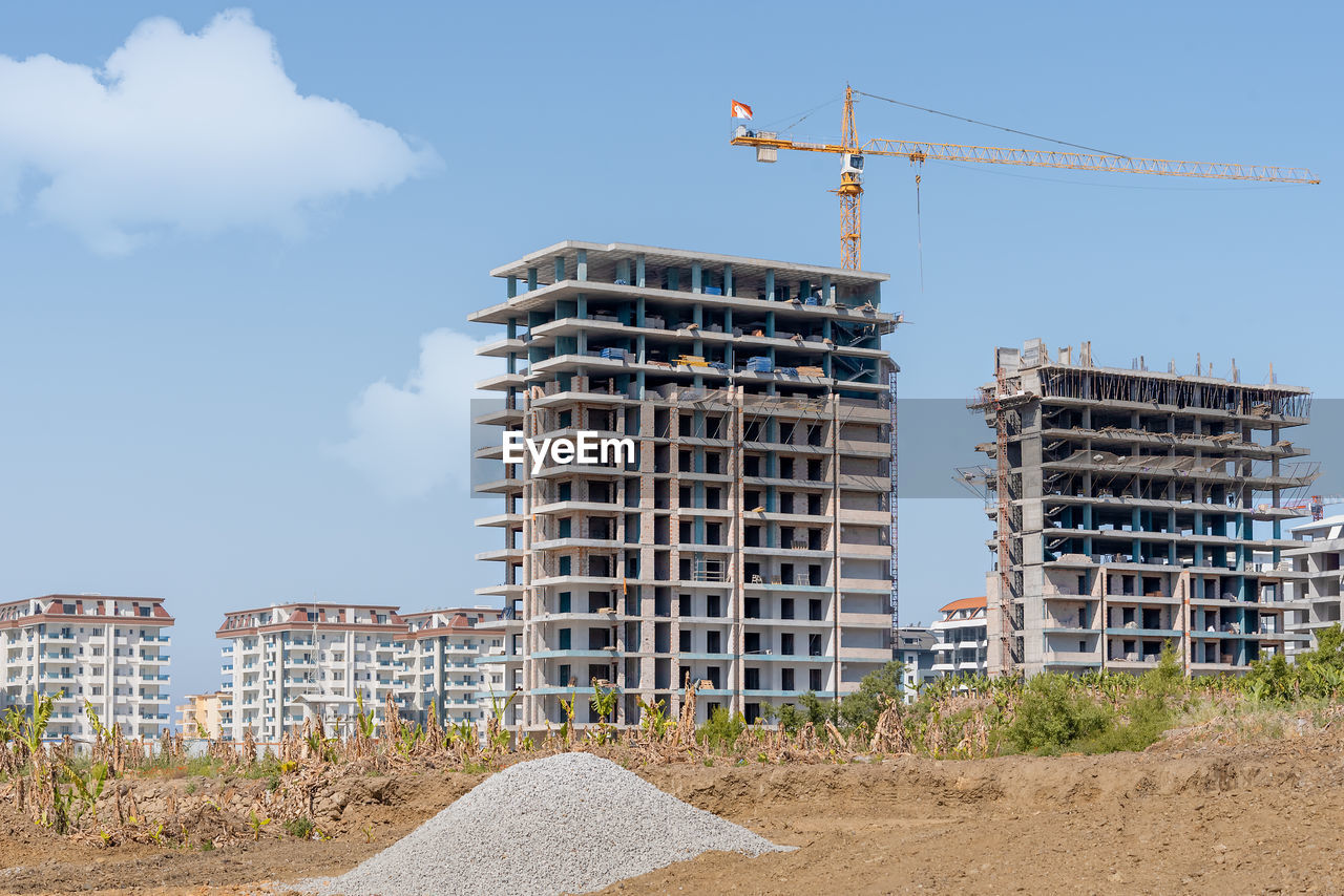 Construction of new residential buildings on the background of a residential area in turkey.