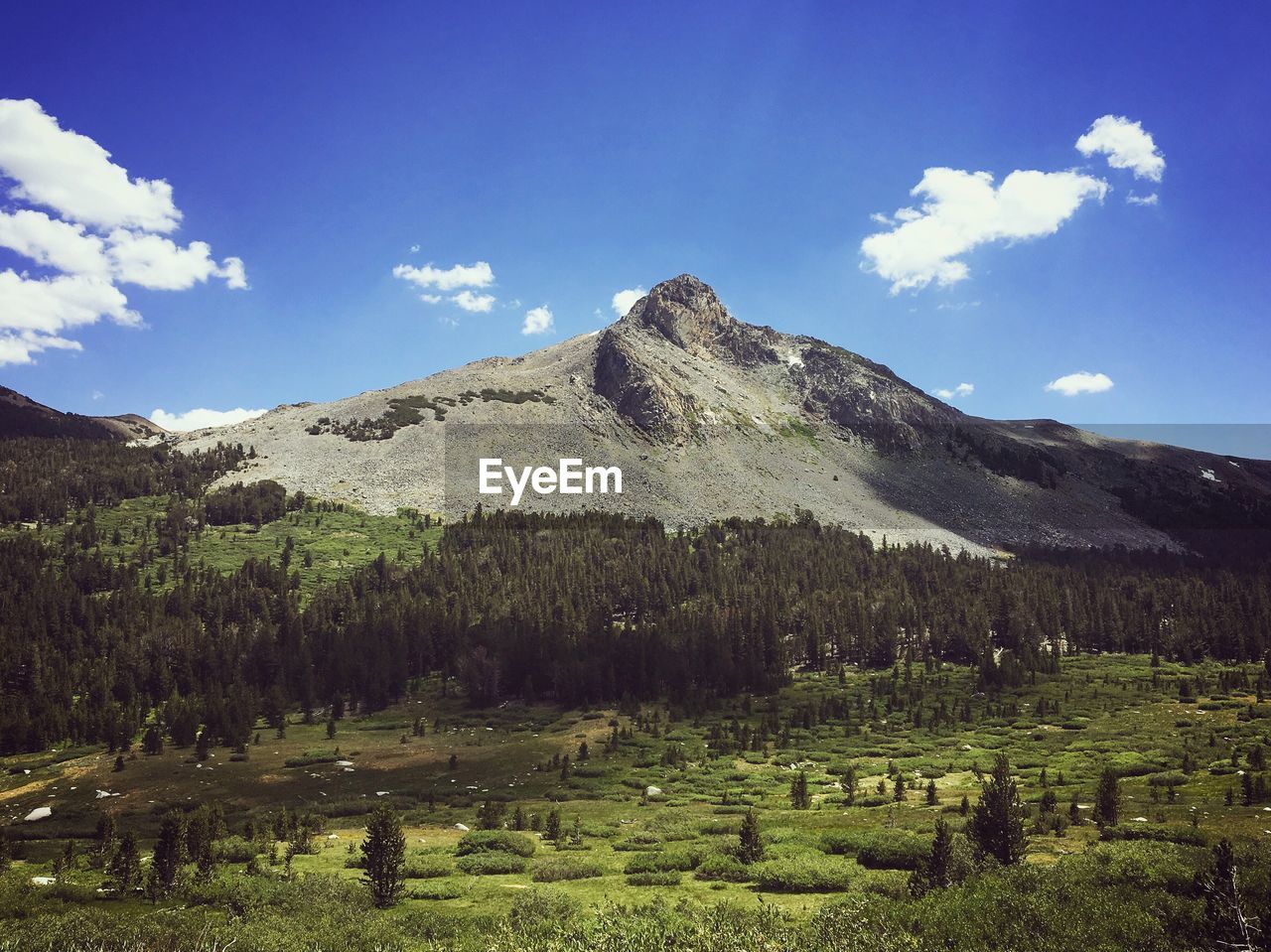 Scenic view of mountains against cloudy sky