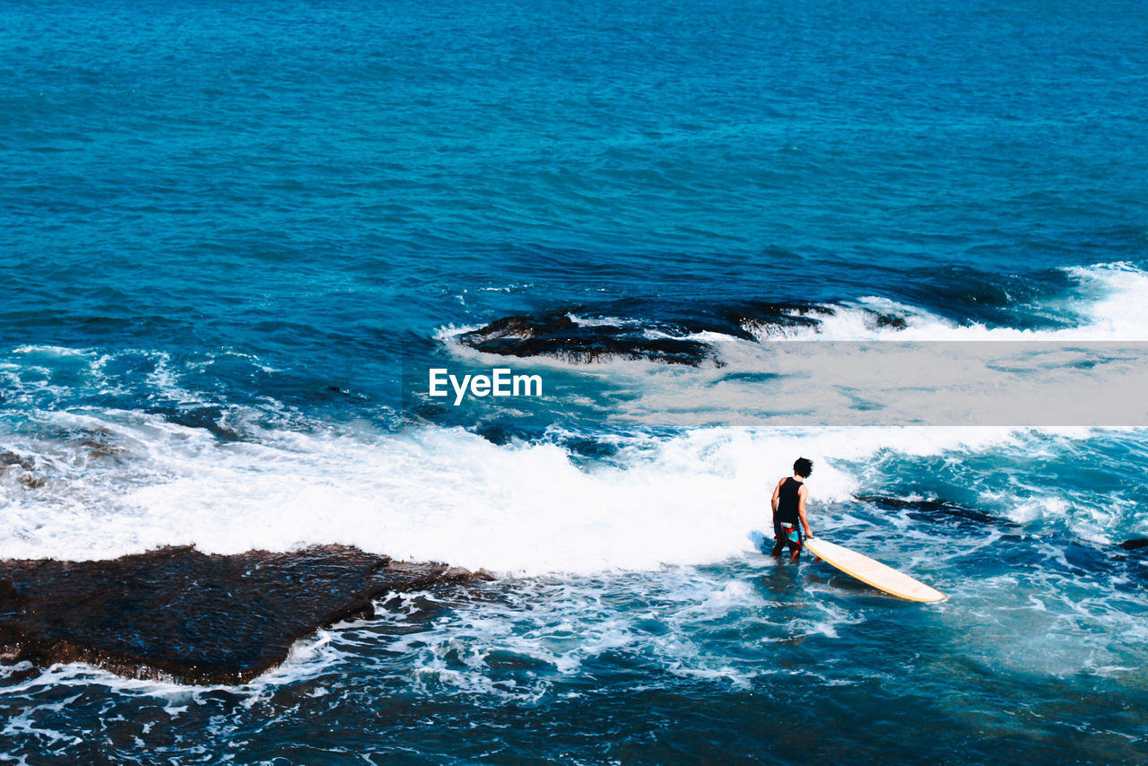 High angle view of man surfing in sea