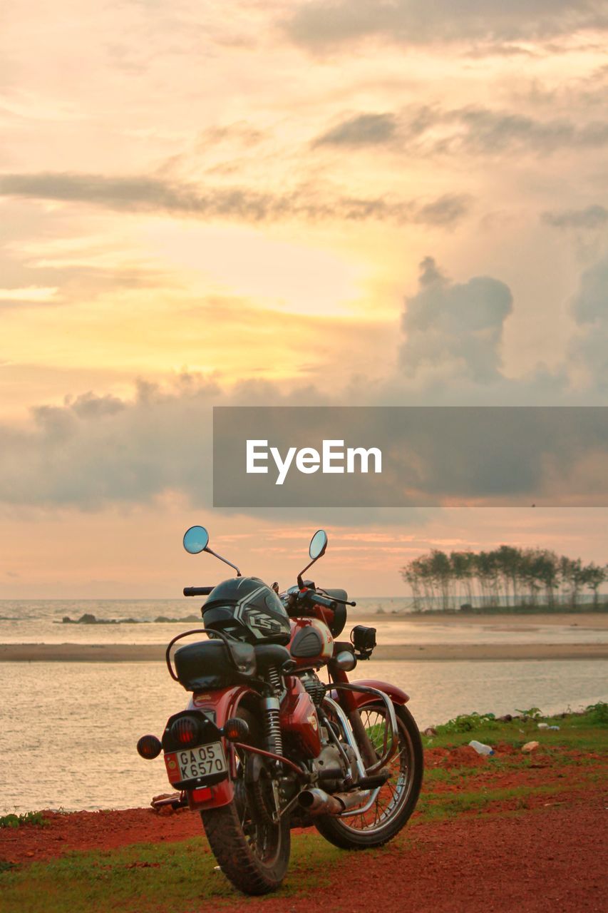 BICYCLE ON BEACH AGAINST SKY