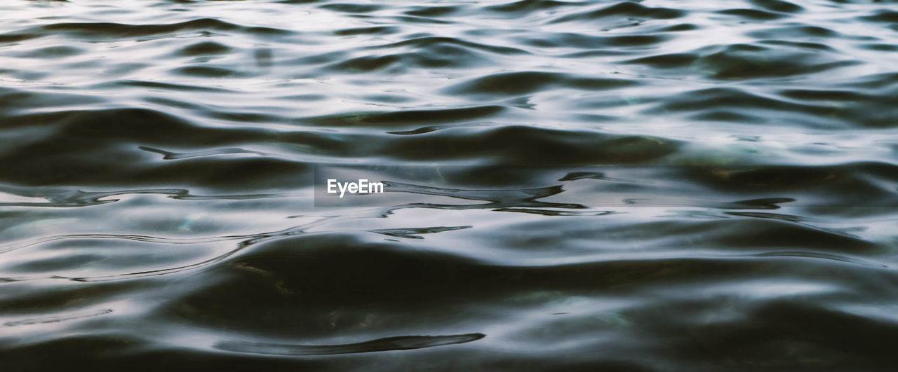 HIGH ANGLE VIEW OF RIPPLED WATER SURFACE