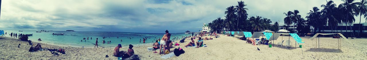 PANORAMIC VIEW OF PEOPLE AT BEACH