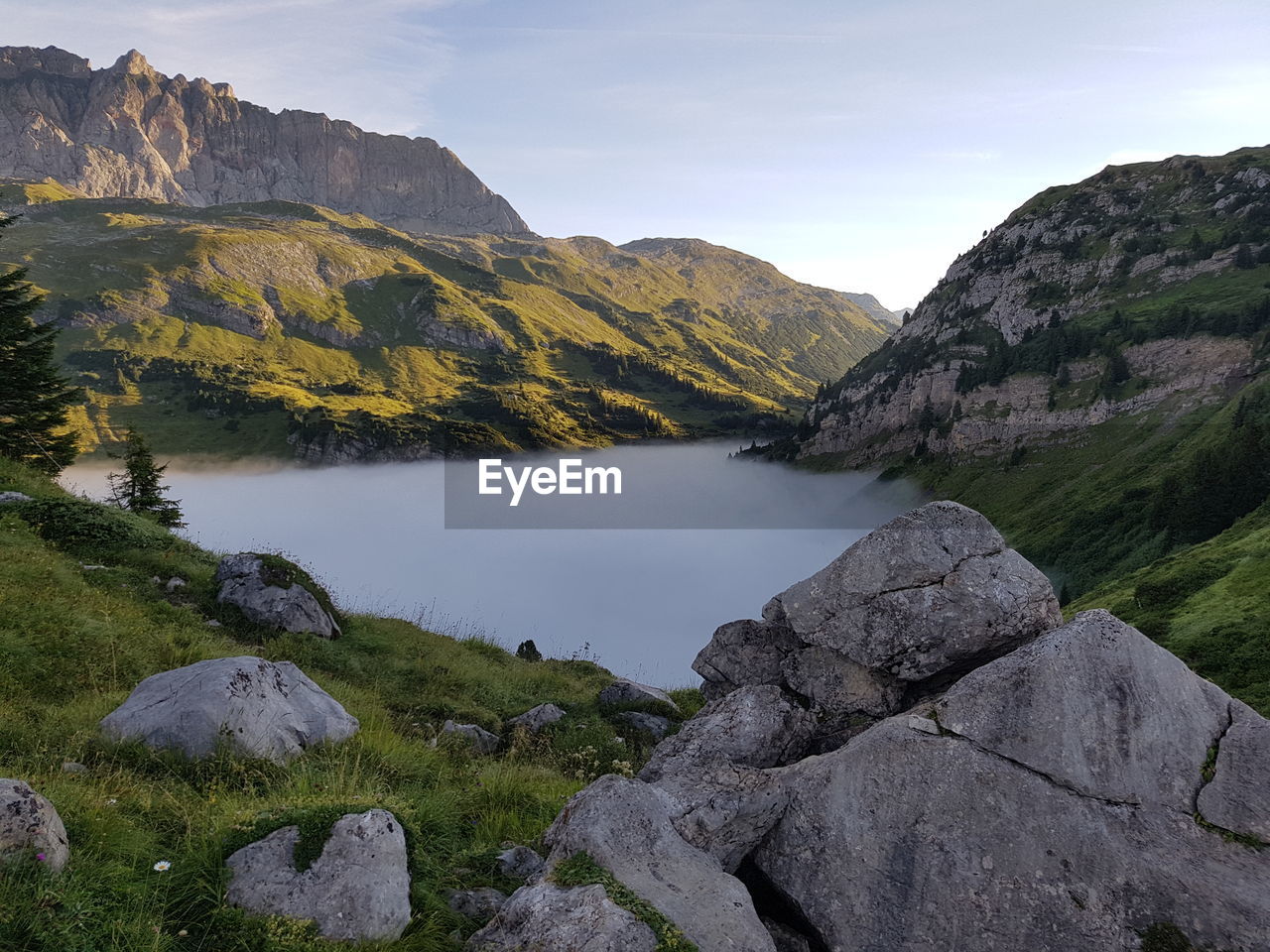 Scenic view of lake and mountains against sky