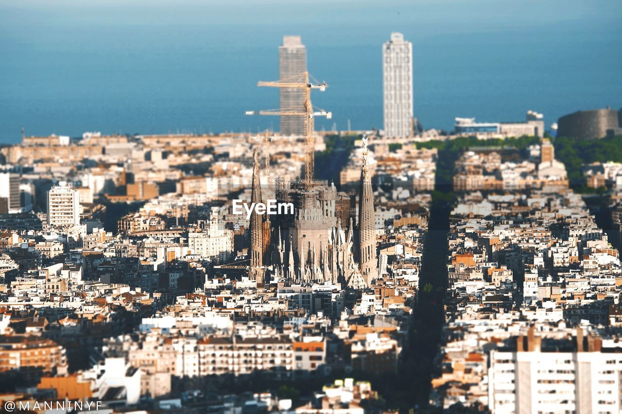 HIGH ANGLE VIEW OF BUILDINGS AND CITY AT WATERFRONT